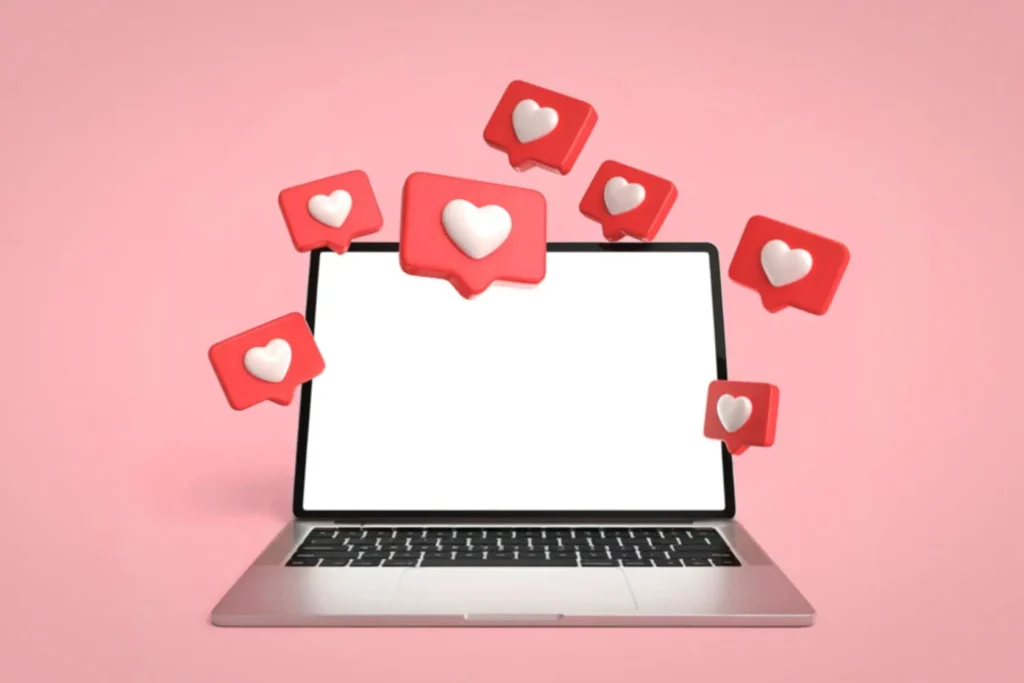 Ordinateur portable sur fond rose avec icônes cœur flottantes, image d’un profil Pinterest en pleine optimisation