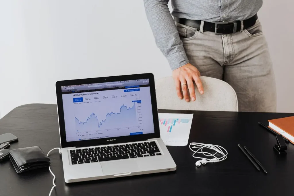 Laptop affichant courbe BTCUSD sur bureau, image évoquant la valorisation d'une startup par suivi des marchés et innovation digitale.