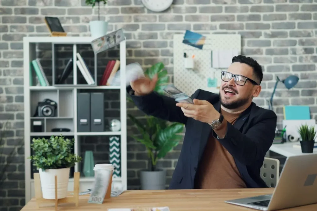 Personne souriante lance argent dans bureau, image d’un travailleur indépendant qui définit ses tarifs avec confiance et stratégie.